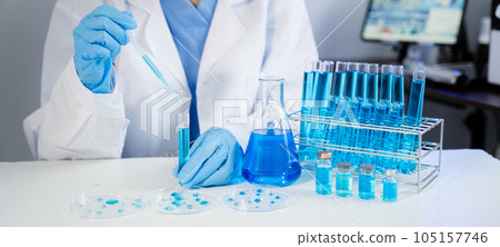 Healthcare professional holding  vaccine in laboratory study and analyze scientific sample of antibody. 105157746