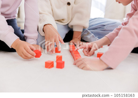 Children's hands doing building blocks 105158163