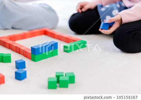 Children's hands doing building blocks 105158167