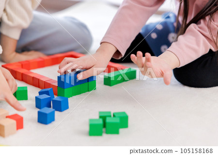Children's hands doing building blocks 105158168