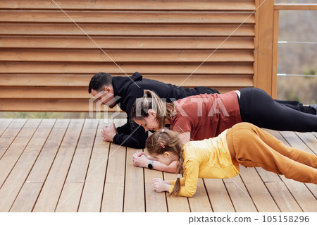Happy family are stretching outdoors Happy family are stretching outdoors 105158296