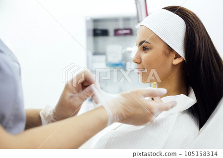 Dermatologist or cosmetologist start procedures in spa salon or clinic 105158314