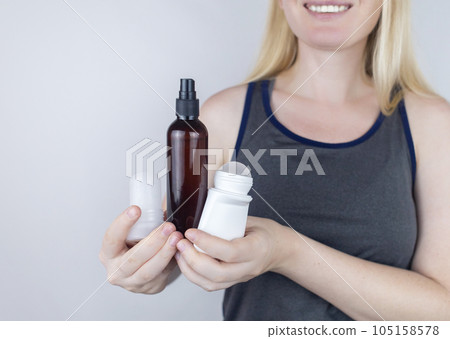 Girl holds in her hands three eco-friendly antiperspirants with natural ingredients. Refusal of antiperspirants containing toxic substances. Freedom from Aluminum chlorohydrate, alcohol, parabens Girl holds in her hands three eco-friendly antiperspirants with natural ingredients. Refusal of antiperspirants containing toxic substances. Freedom from Aluminum chlorohydrate, alcohol, parabens 105158578