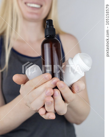 Girl holds in her hands three eco-friendly antiperspirants with natural ingredients. Refusal of antiperspirants containing toxic substances. Freedom from Aluminum chlorohydrate, alcohol, parabens Girl holds in her hands three eco-friendly antiperspirants with natural ingredients. Refusal of antiperspirants containing toxic substances. Freedom from Aluminum chlorohydrate, alcohol, parabens 105158579