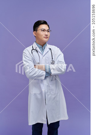 Portrait of male confident doctor over purple background studio, healthcare and Medical technology concept. 105158696