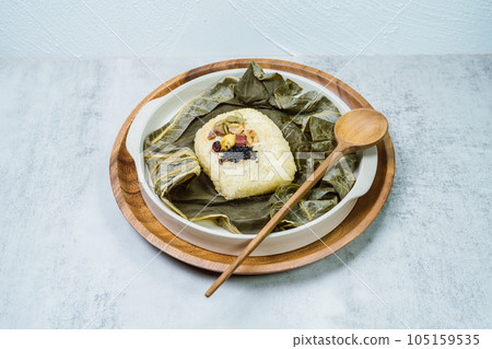 yeonnipbap, korean lotus leaf rice, Glutinous rice, dates, and chestnuts wrapped in a lotus leaf and steamed in a steamer. In the past, this dish was made and consumed by Buddhist monks, but it is now 105159535