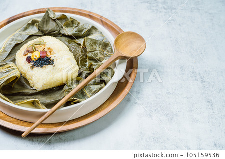 yeonnipbap, korean lotus leaf rice, Glutinous rice, dates, and chestnuts wrapped in a lotus leaf and steamed in a steamer. In the past, this dish was made and consumed by Buddhist monks, but it is now 105159536