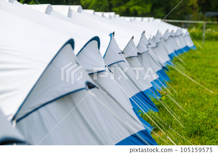 Set row of tents on meadow 105159575