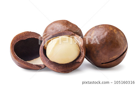 Macadamia nuts and broken close-up on a white background. Macadamia nuts and broken close-up on a white background. 105160316