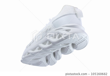 White sports sneakers with corrugated soles on a white background. 105160682