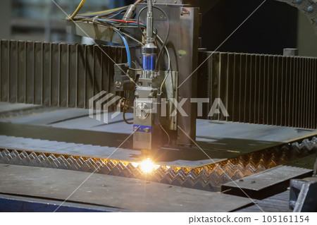 Cutting of metal. Sparks fly from laser.Laser cutting machine working with sheet metal with sparks at factory, plant. Cutting of metal. Sparks fly from laser.Laser cutting machine working with sheet metal with sparks at factory, plant. 105161154