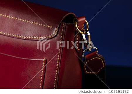 Part of a leather bag on a dark background. 105161182