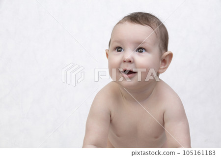 Six month old baby on a white background. Happy boy mid-range. Conceptual photo of fatherhood and motherhood.Alpha generation. 105161183