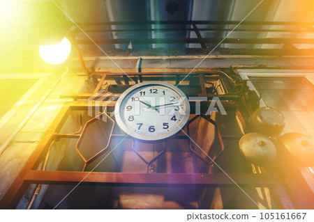 Clock in a multi-colored gradient on old metal supports. Time is running out forever.Fabulous clock of the old station. Clock in a multi-colored gradient on old metal supports. Time is running out forever.Fabulous clock of the old station. 105161667