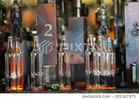 Glassworks. Glass industry. The process of making glass bottles. 105161975