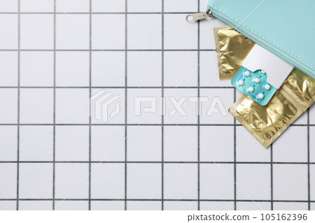 Handbag with condoms and birth control pills, place for text Handbag with condoms and birth control pills, place for text 105162396