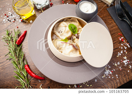 Black Angus beef hand-made dumplings. Cucumber-julienne with chilli-garlic butter and sour cream. Delicious healthy traditional food closeup served for lunch in modern gourmet cuisine restaurant 105163705
