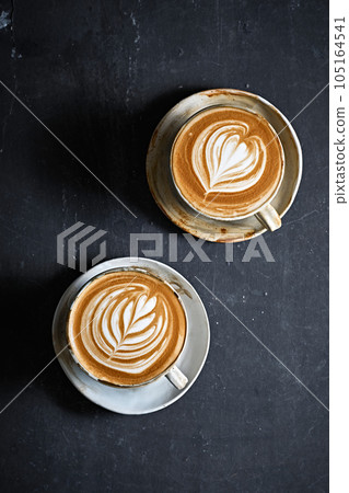 hot latte art coffee on dark background 105164541