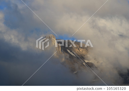 Peak of Mount Gstellihore visible trough a window in the clouds. Peak of Mount Gstellihore visible trough a window in the clouds. 105165320