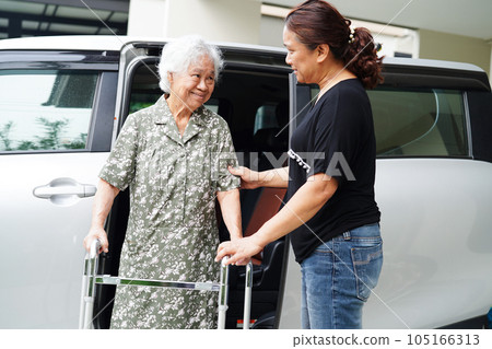 Caregiver help Asian elderly woman disability patient get in her car, medical concept. Caregiver help Asian elderly woman disability patient get in her car, medical concept. 105166313
