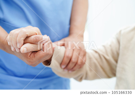 Doctor holding hands Asian elderly woman patient, help and care in hospital. 105166330