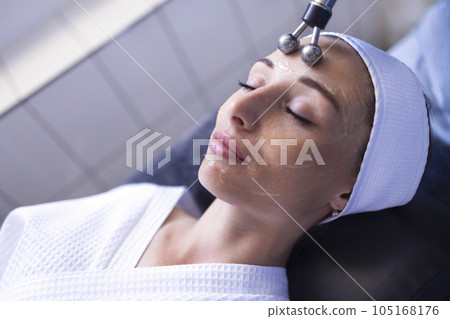Microcurrent medicine treatment. Portrait of beautiful woman. Microcurrent medicine treatment. Portrait of beautiful woman. 105168176