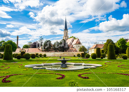 A beautiful European park and a view of the fountain and the church in summer. A beautiful European park and a view of the fountain and the church in summer. 105168317