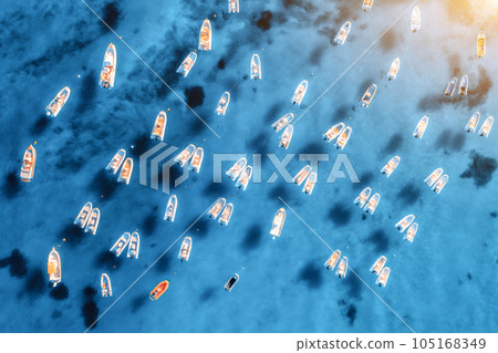Aerial view of many motorboats on blue sea at sunrise in summer 105168349