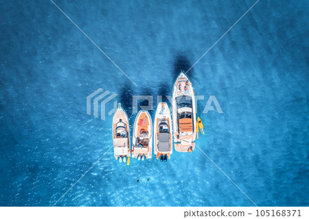 Aerial view of luxury yachts and boats on blue sea at sunrise 105168371