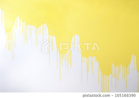 A half painted concrete white wall. Streams and drops of yellow paint on a white background. A half painted concrete white wall. Streams and drops of yellow paint on a white background. 105168390