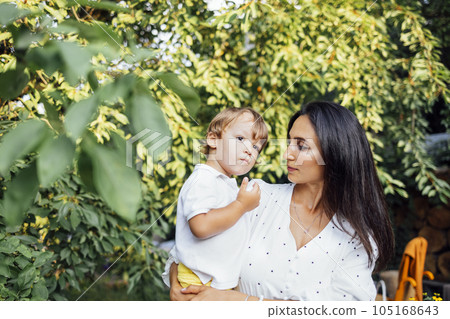 Lovely portrait of a beautiful mother hugging her little son 105168643