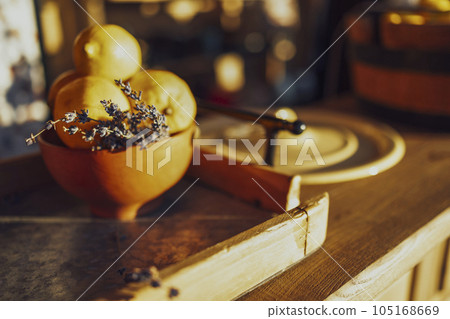Extrime closeup of vertical view of a wooden bucket full of fresh lemons and sprig of lavender Extrime closeup of vertical view of a wooden bucket full of fresh lemons and sprig of lavender 105168669