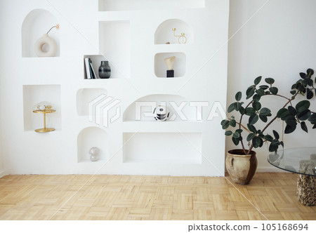 Modern bright interior of living room with white wall and niches. 105168694