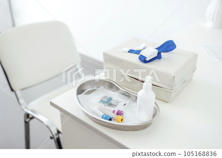 The desktop of a medical worker or nurse. Blood collection devices on a white table. The desktop of a medical worker or nurse. Blood collection devices on a white table. 105168836
