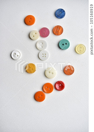 Multicolored buttons on a white background. Round buttons from clothes. 105168919