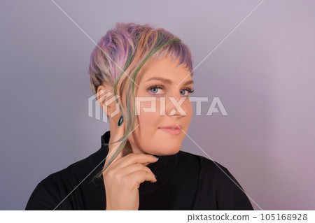 Cute pretty girl portrait European with stylish hairstyle colored coloring bob square on the background of the studio 105168928