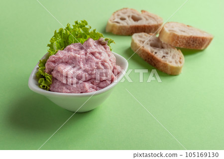 A bowl tarama or taramasalata and several toasts on the light green background A bowl tarama or taramasalata and several toasts on the light green background 105169130