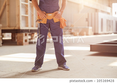 Male builder standing inside building under construction Male builder standing inside building under construction 105169428