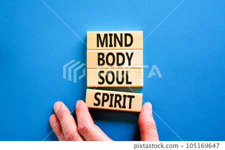 Mind body soul spirit symbol. Concept words Mind Body Soul Spirit on wooden blocks. Beautiful blue table blue background. Businessman hand. Lifestyle mind body soul spirit concept. Copy space. 105169647