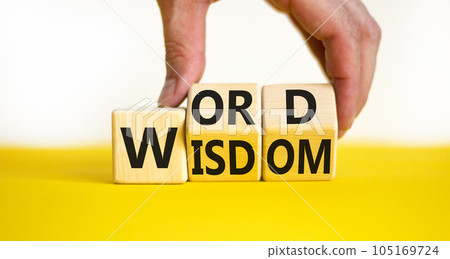 Wisdom word symbol. Concept words Wisdom word on wooden cubes. Businessman hand. Beautiful yellow table white background. Business and wisdom word concept. Copy space. 105169724