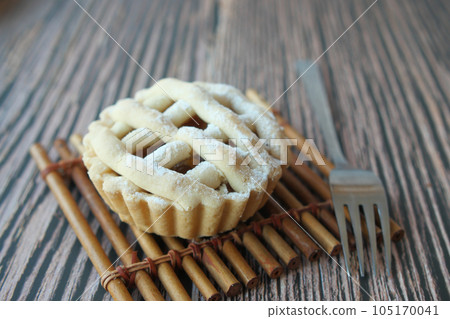 Homemade apple pie with lattice pastry on table  105170041