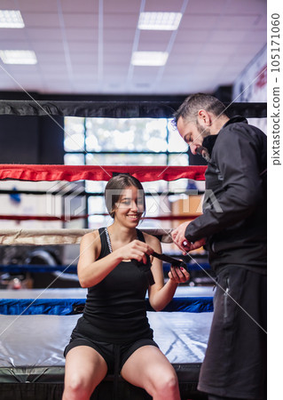 K1 Kickboxing sport fitness gym trainer help with bandage protection. Young woman and mature man 105171060