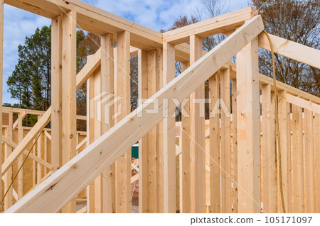 During construction phase there are support beams built wooden frame is being developed for new house 105171097