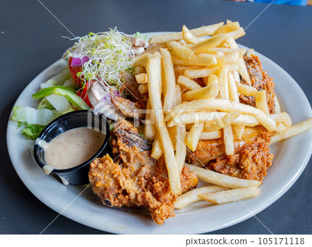 Close up shot of deep fried French fries and fried chicken 105171118