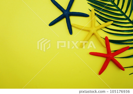Summer Background with starfish and green leave on yellow background Summer Background with starfish and green leave on yellow background 105176936