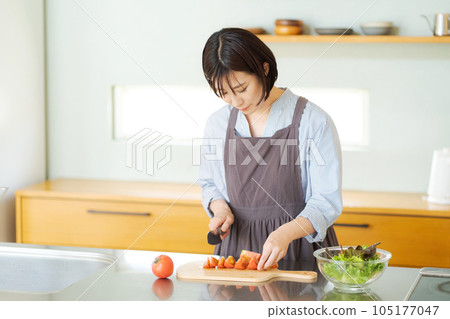Photo of a woman cutting vegetables Photo of a woman cutting vegetables 105177047