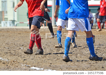 Soccer on a muddy ground Soccer on a muddy ground 105177596