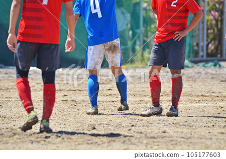 Soccer on a muddy ground 105177603