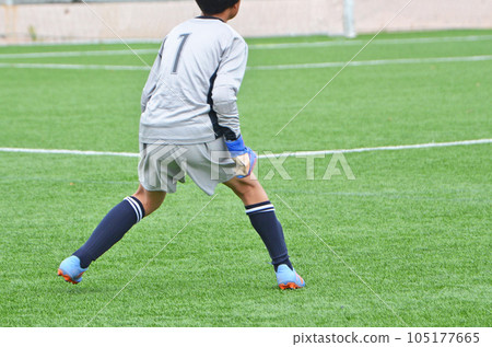 Youth soccer match played on artificial turf (goalkeeper ready) 105177665