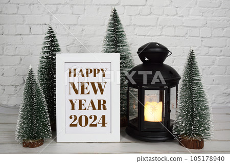 2024 Happy New Year Holiday background with pine tree and lantern on white brick wall 105178940